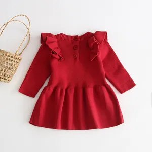 Red baby girl knitted dress back view with cute shoulder ruffles, long sleeves, and sweet button details.