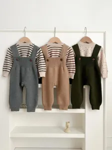 Baby knit strap pants detail showing soft knit texture, cute buttons and cozy autumn style.
