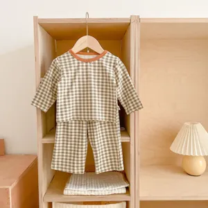 Baby cotton plaid pajama set detail, long sleeve top and pants, cozy toddler homewear style.