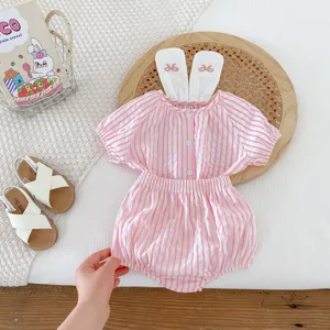 Detailed shot of adorable baby girl pink striped two-piece outfit with cute bunny ears.