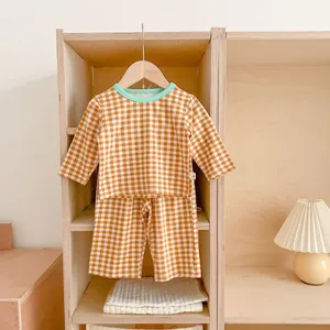 Cute baby cotton gingham two-piece set, long sleeve top and shorts for infants and toddlers.