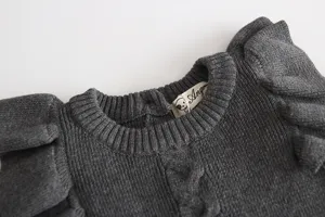 Grey baby knit dress with ruffled shoulders, warm infant princess sweater detail shot.
