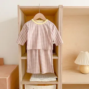 Infant plaid loungewear set detail view, featuring purple checkered top and pants with yellow collar.