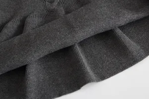 Dark gray baby knit dress hem detail, soft ribbed texture, perfect for autumn and winter wear.