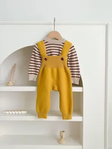 Adorable baby knitted set featuring a striped sweater and yellow suspender pants for infants.