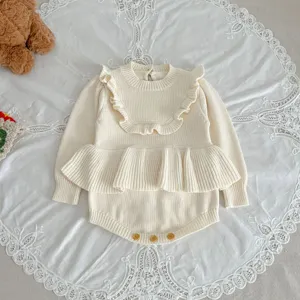 Baby knitted romper detail, cute ruffle shoulder design, comfortable infant clothing.