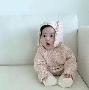 Cute baby knitted hooded sweater with adorable rabbit ears in soft pink color for infants.