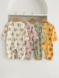 Detailed shot of newborn baby waffle long-sleeve rompers featuring cute animal prints.