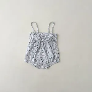 Infant floral print swimsuit detail showcasing cute front bow and delicate spaghetti straps.