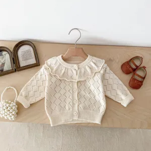 Close-up of off-white baby knit cardigan with hollow-out pattern and large ruffled collar.