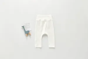 Detailed view of pure cotton baby ribbed high-waist pants paired with a cute toy prop.