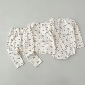 Detailed view of infant floral baby clothing set, showcasing soft fabric and cute flower print.