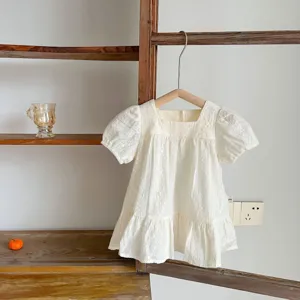 Infant summer embroidered white puff sleeve dress detail view with delicate lace hem