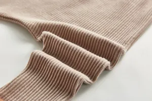 Cotton ribbed fabric detail of baby trousers, soft texture, comfortable fit for infants.
