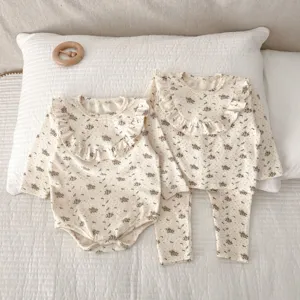 Infant floral baby girl homewear detail, cotton long sleeve romper and pajamas set.