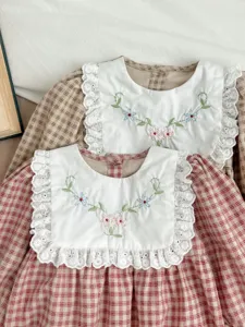 Infant baby girl plaid romper detail, white lace lapel collar with floral embroidery.
