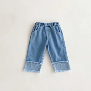 Kids blue washed denim pants with elastic waist and frayed cuffs for girls casual wear