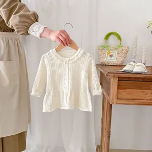 Delicate hollow-out knit baby cardigan detail, cute ruffle collar, soft cotton yarn fabric.