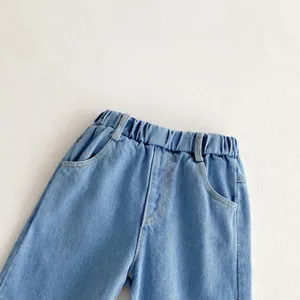 Detailed view of kids loose wide-leg washed denim jeans, elastic waist and front pockets.