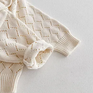 Detailed view of the baby toddler knit sweater featuring delicate hollow-out pattern and ruffles.