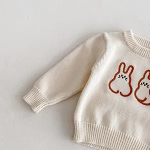 Baby knit sweater detail view, cute rabbit embroidery, soft cotton yarn fabric, cozy baby top.