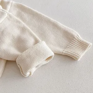 Baby knit sweater sleeve detail, soft cotton fabric, cozy and warm infant top apparel.