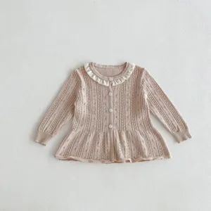 Infant baby girl knit cardigan detail, delicate hollow-out pattern and cute ruffled collar.