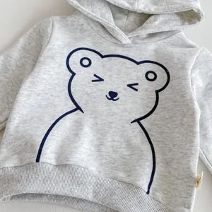 Detalle sudadera gris niño, estampado oso tierno, tejido suave, ropa cómoda para bebé.