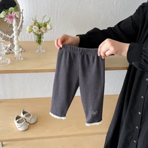 Infant ribbed leggings with lace trim and cute bow embroidery detail for baby girls.