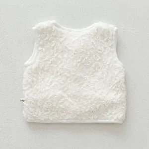 Soft white lambswool baby vest detail showing fluffy texture and neat sleeveless cut.