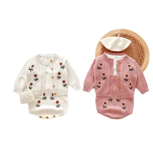 Set cardigan e tutina in maglia per bambina con ricamo floreale e accessori graziosi.