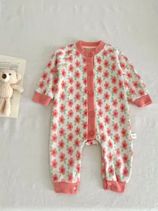 Detailed shot of baby floral knit romper, cozy long sleeve jumpsuit with cute buttons for infants.