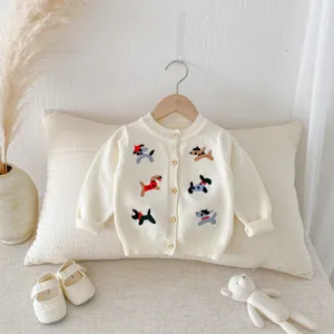 Detailed view of baby knitted cardigan featuring cute puppy embroidery and wooden buttons.