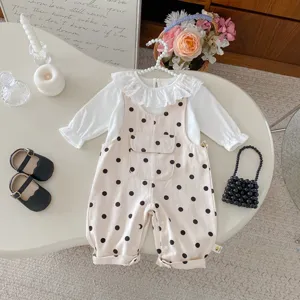 Detailed view of infant baby girl polka dot overall jumpsuit set with cute ruffled collar top.