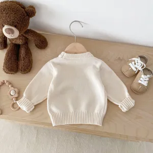 Detailed view of baby knit sweater featuring a classic round neck and cozy pullover style.
