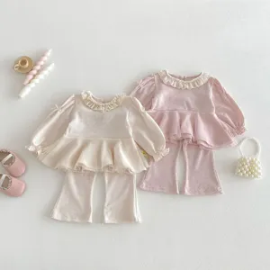Details of toddlers girls ruffle blouse and flare pants set, cute mesh bow design for spring.