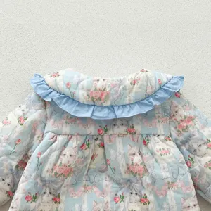 Close-up detail of infant baby thickened padded romper with cat print and ruffles.