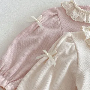 Close-up detail of girls long-sleeve doll shirt featuring delicate lace collar and cute bow knots.