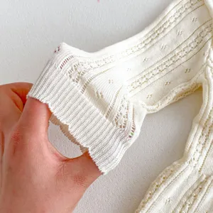 Baby knit cardigan sleeve detail, breathable hollow-out cotton knit fabric for summer.