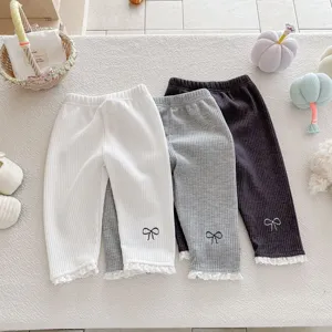 Cute infant toddler girls waffle knit leggings with delicate lace hem and sweet bow embroidery.