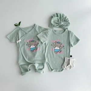 Mint green ribbed baby summer short sleeve top pants set with cute cartoon bear print detail.