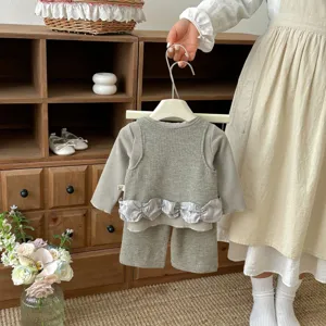 Detail view of baby waffle knit long sleeve top and pants set with shiny ruffled design.