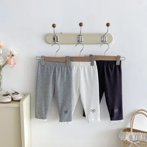 Baby ribbed leggings detail shot featuring cute lace hem and sweet bow embroidery design.