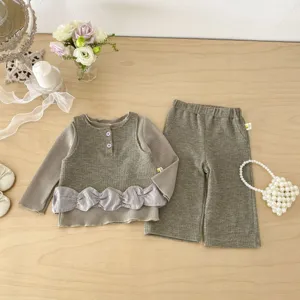 Detail view of Korean style waffle knit baby girls clothing set with cute ruffled hem and pants.