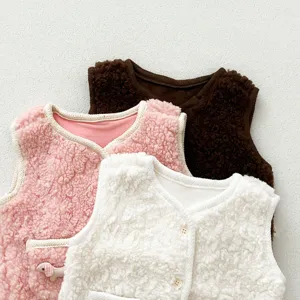 Detail shot of thickened lamb wool baby vests in pink white and brown colors close up texture