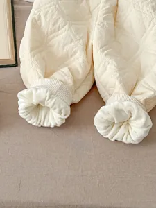 Infant padded winter thermal trousers detail, quilted thick warm baby clothing piece.