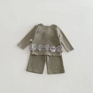 Detailed view of baby toddler waffle knit 3-piece set featuring long sleeve top, vest and pants.