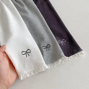Infant waffle leggings detail showing cute embroidered bow and lace trim design for baby girls.