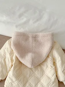 Infant winter quilted jacket detail, warm fleece-lined hooded baby winter coat cozy apparel.