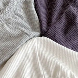 Baby waffle knit leggings fabric detail close up showing grey purple and white colors style.